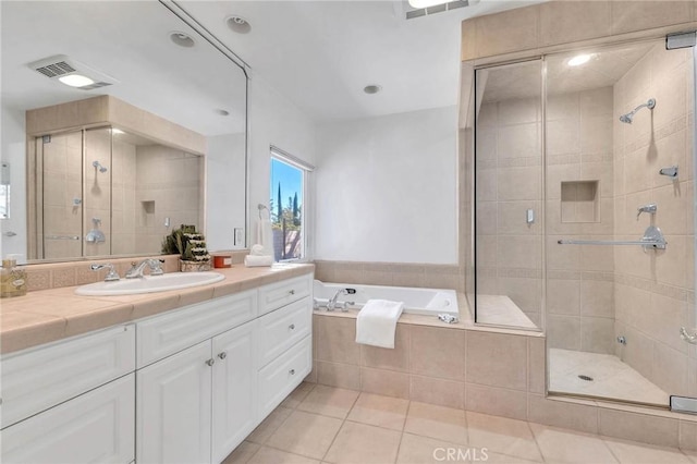 bathroom with tile patterned floors, vanity, and plus walk in shower