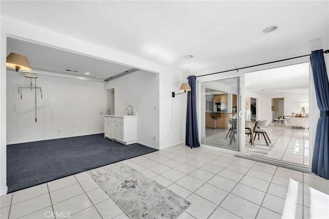 interior space with sink and light tile patterned flooring