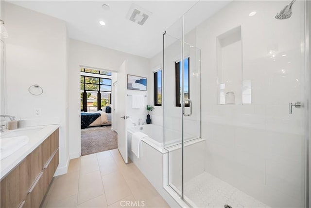 bathroom featuring plus walk in shower, tile patterned flooring, and vanity