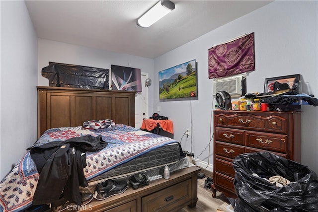 bedroom featuring cooling unit and light hardwood / wood-style flooring