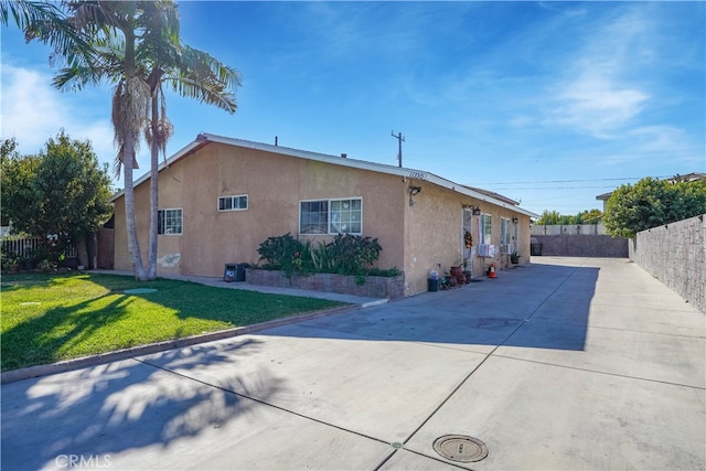 view of side of property with a patio and a yard