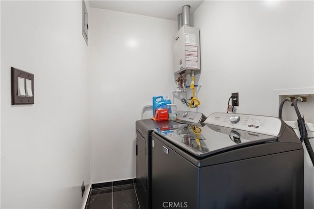 clothes washing area with water heater and washing machine and dryer