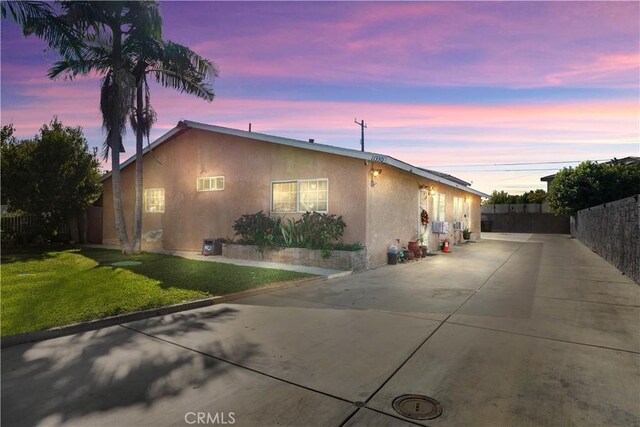 view of front of house featuring a yard and a patio