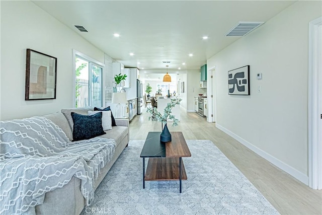 2942 S W View St, Los Angeles, CA 90016 - living room featuring light wood-style floors, recessed lighting, and baseboards