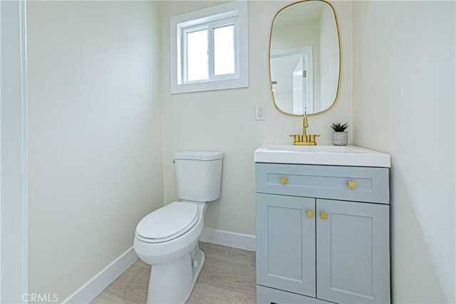 2942 S W View St, Los Angeles, CA 90016 - bathroom featuring toilet, vanity, baseboards, and wood finished floors