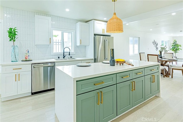 2942 S W View St, Los Angeles, CA 90016 - kitchen with appliances with stainless steel finishes, a sink, green cabinetry, white cabinetry, and recessed lighting