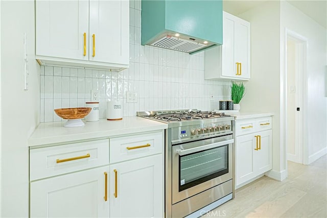 2942 S W View St, Los Angeles, CA 90016 - kitchen with stainless steel range with gas cooktop, custom range hood, backsplash, and light countertops