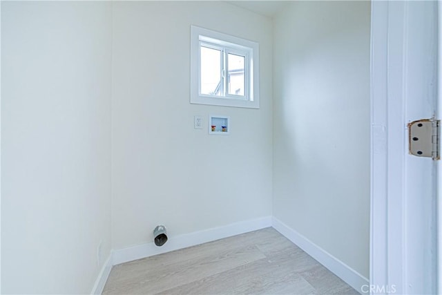 2942 S W View St, Los Angeles, CA 90016 - washroom with hookup for a washing machine, light wood-style floors, and baseboards