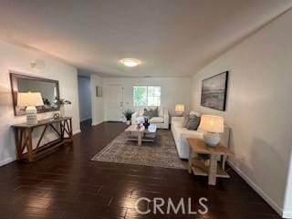 living room with dark hardwood / wood-style flooring