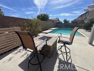 view of pool featuring a patio and a fire pit