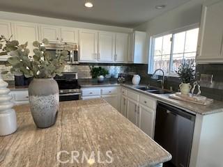 kitchen featuring white cabinetry, sink, and stainless steel appliances