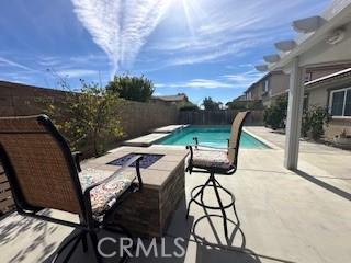 view of pool featuring a patio and an outdoor fire pit