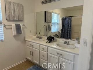 bathroom featuring a shower with shower curtain, vanity, and tile patterned floors