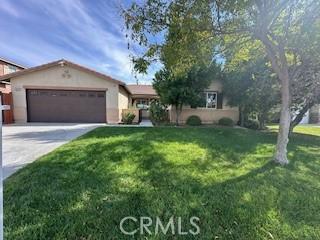 ranch-style home with a front yard and a garage