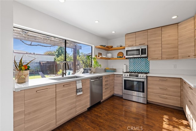 kitchen with decorative backsplash, sink, stainless steel appliances, and dark wood-type flooring