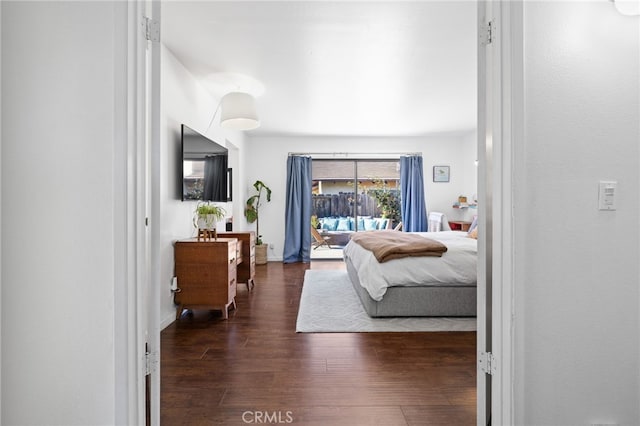 bedroom with dark hardwood / wood-style flooring