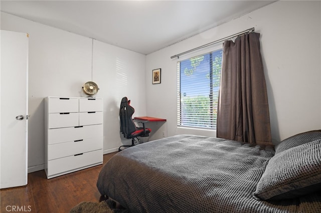 bedroom with dark wood-type flooring