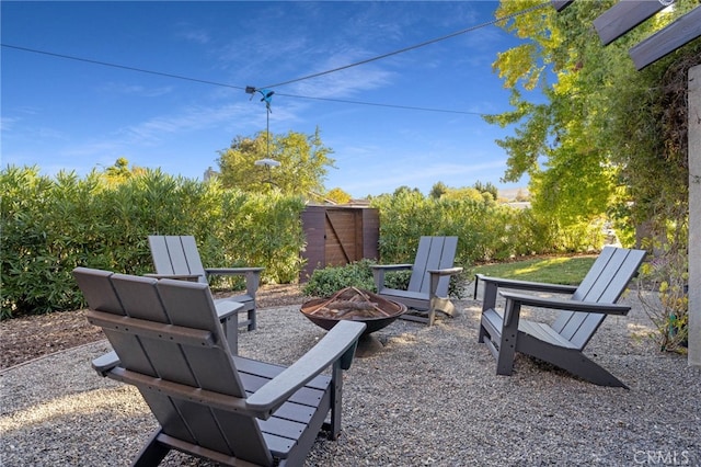 view of patio / terrace featuring an outdoor fire pit