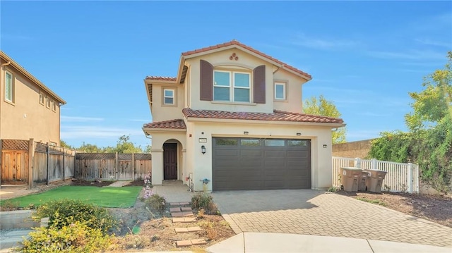 mediterranean / spanish home with a front yard and a garage