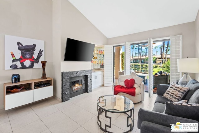 tiled living room with a stone fireplace and high vaulted ceiling