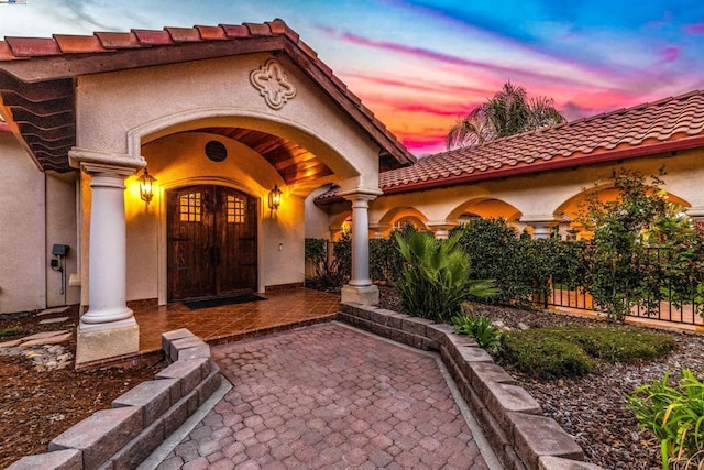 view of exterior entry at dusk