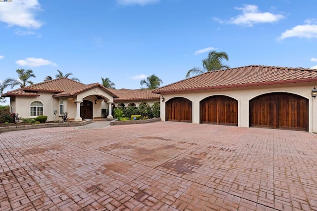 mediterranean / spanish house featuring a garage