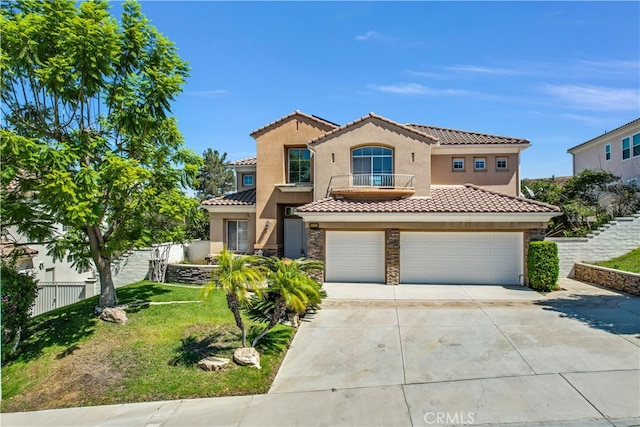 mediterranean / spanish house featuring a front lawn and a garage