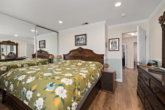 bedroom featuring hardwood / wood-style flooring, a closet, and ornamental molding