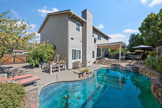 rear view of house featuring a patio area, a fenced in pool, and a pergola