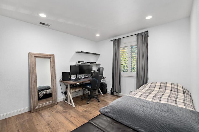 bedroom with wood-type flooring