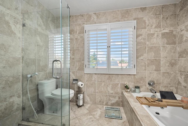 bathroom with toilet, tile walls, and separate shower and tub