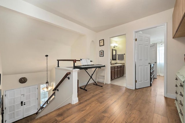 interior space with hardwood / wood-style floors and lofted ceiling