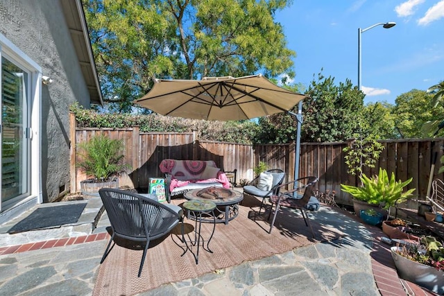 view of patio / terrace featuring an outdoor living space with a fire pit