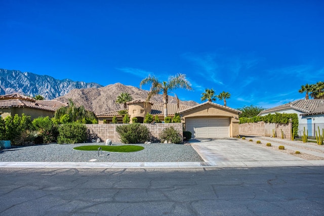 view of front of house with a mountain view and a garage