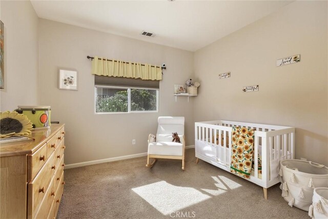 carpeted bedroom with a crib