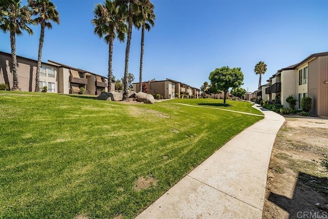 view of property's community with a lawn