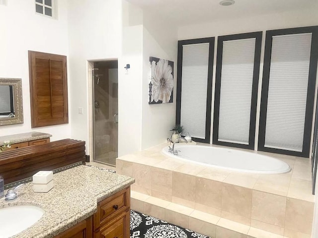 bathroom featuring tile patterned floors, vanity, and independent shower and bath