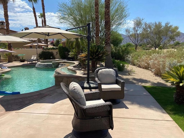 view of swimming pool with an in ground hot tub and a patio