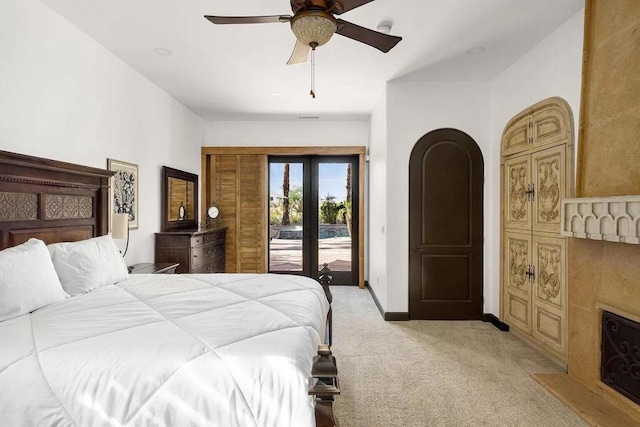 bedroom featuring light carpet, french doors, access to outside, and ceiling fan