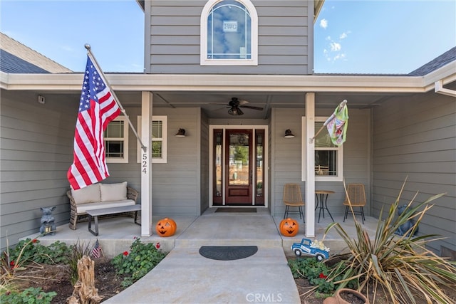 doorway to property featuring a porch and ceiling fan