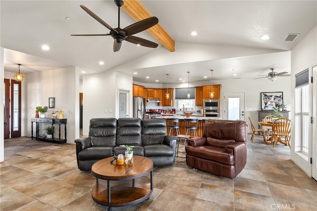 living room with beamed ceiling, high vaulted ceiling, and ceiling fan