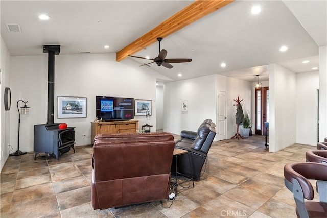 living room with a wood stove, beamed ceiling, high vaulted ceiling, and ceiling fan