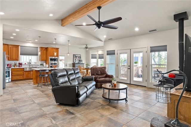 living room featuring sink, french doors, ceiling fan, beamed ceiling, and high vaulted ceiling