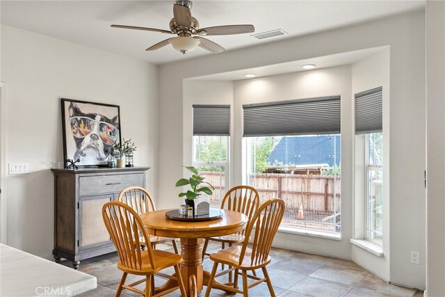 dining space featuring light tile patterned flooring and ceiling fan