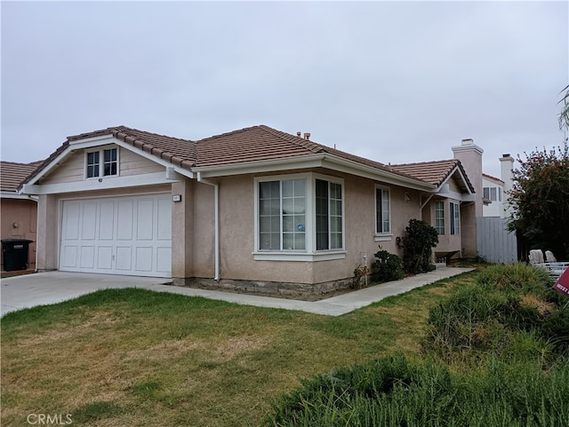 single story home with a front yard and a garage