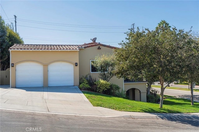 mediterranean / spanish-style home featuring a garage and a front lawn