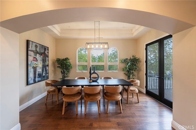 dining room with french doors, dark hardwood / wood-style floors, and a tray ceiling