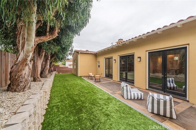 view of yard with a patio area and french doors