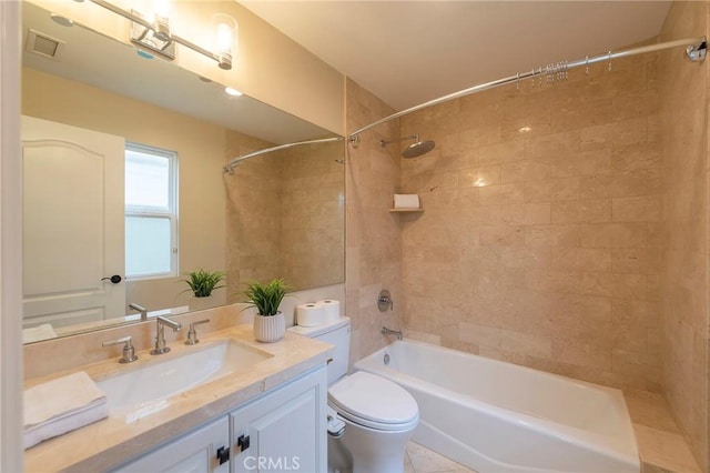 full bathroom featuring vanity, toilet, and tiled shower / bath combo