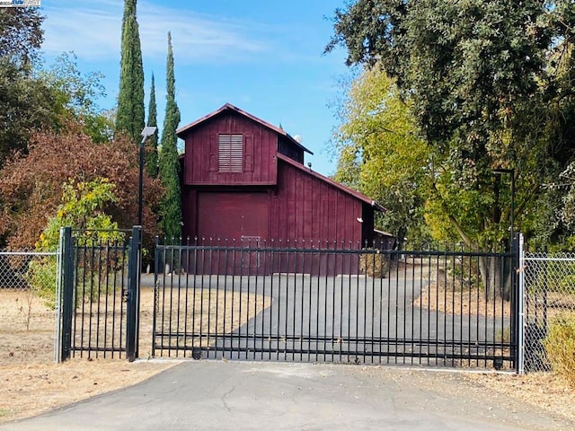 view of gate featuring an outdoor structure